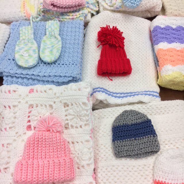 afghans, mittens, and hats for sale at the library